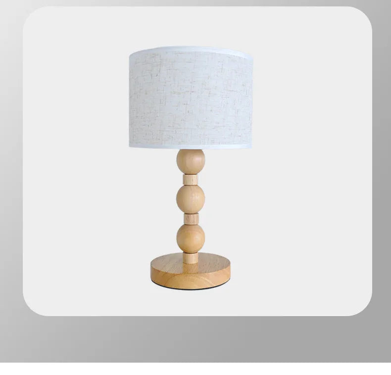 Table lamp with wooden base and white lampshade on a light gray background