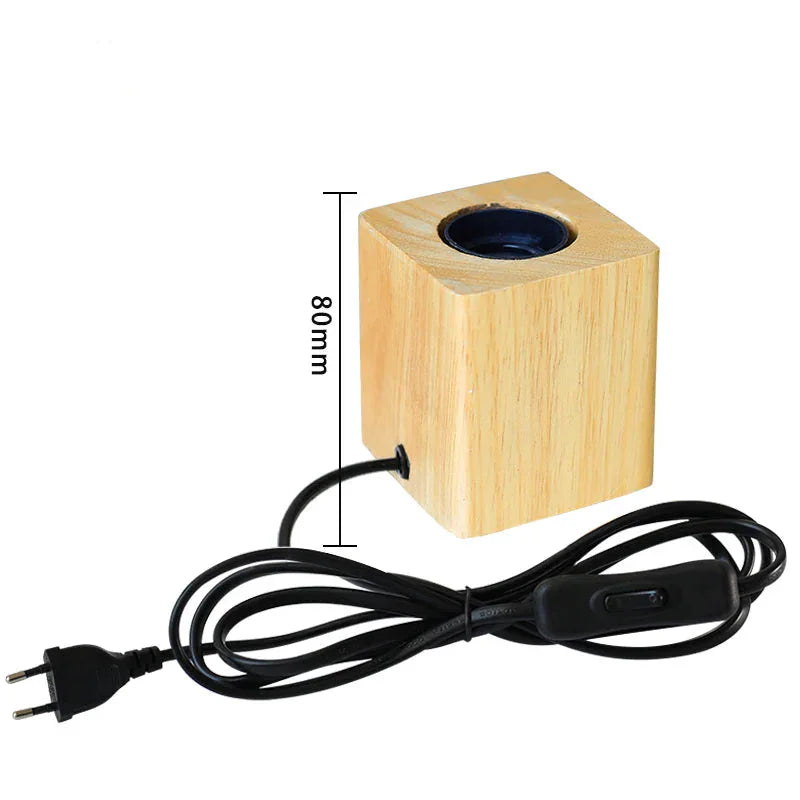 Wooden cube-shaped lamp with black cord and plug